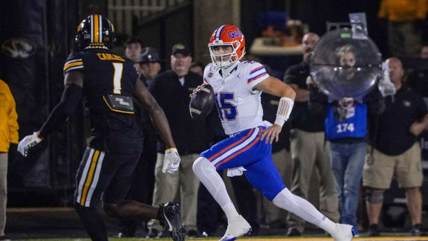 Nov 18, 2023; Columbia, Missouri, USA; Florida Gators quarterback Graham Mertz (15) runs the ball as Missouri Tigers defensive back JC Carlies (1) chases during the first half at Faurot Field at Memorial Stadium. Mandatory Credit: Denny Medley-USA TODAY Sports